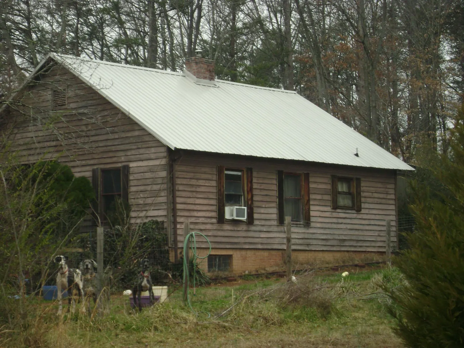 White metal roof on an old wood sided farmhouse, from a Metal Roof Installation job in Barstow